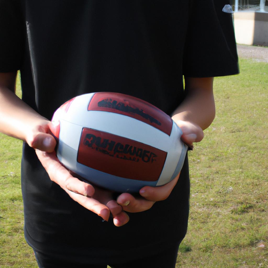 Person holding a football, explaining